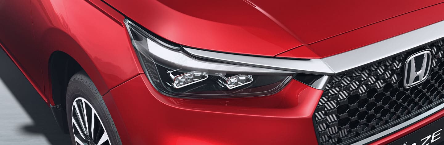 Honda Amaze LED headlamp detail on a red car