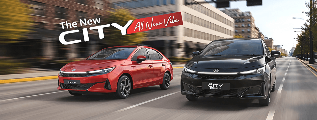 Honda City Facelift in red and City e:HEV in black on a city road
