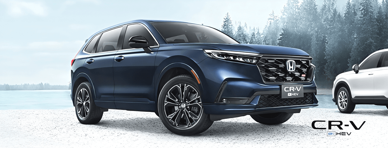 Honda CR-V e:HEV in blue beside a frozen lake