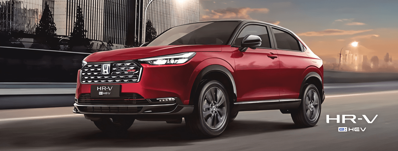 Red Honda HR-V e:HEV on a city street